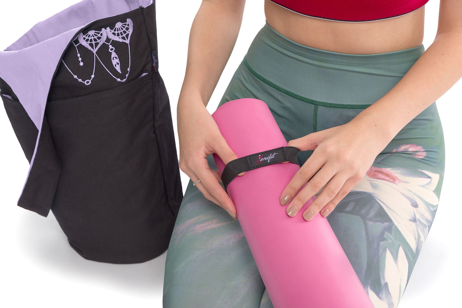 women putting included straps on yoga mat on her knees with yoga bag next to her