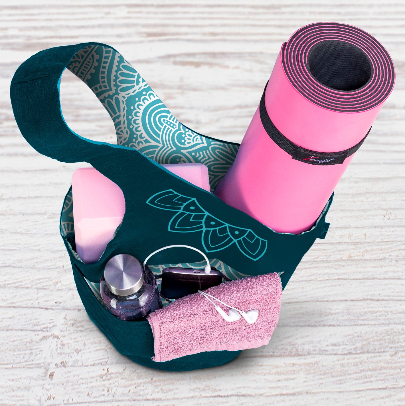 Yoga mat bag two tone teal filled with accessories on the floor view from top